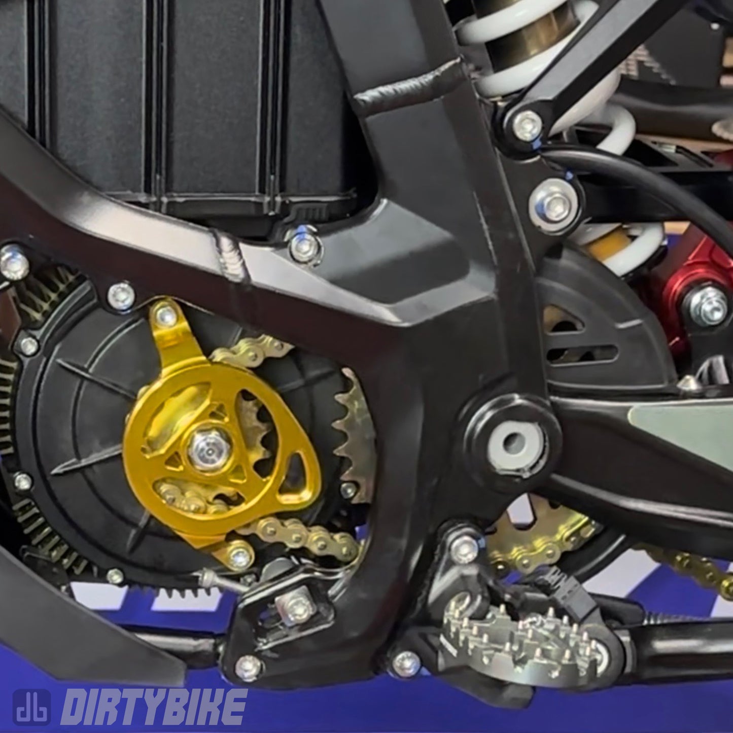 CNC aluminum motor sprocket cover installed on a Surron UltraBee