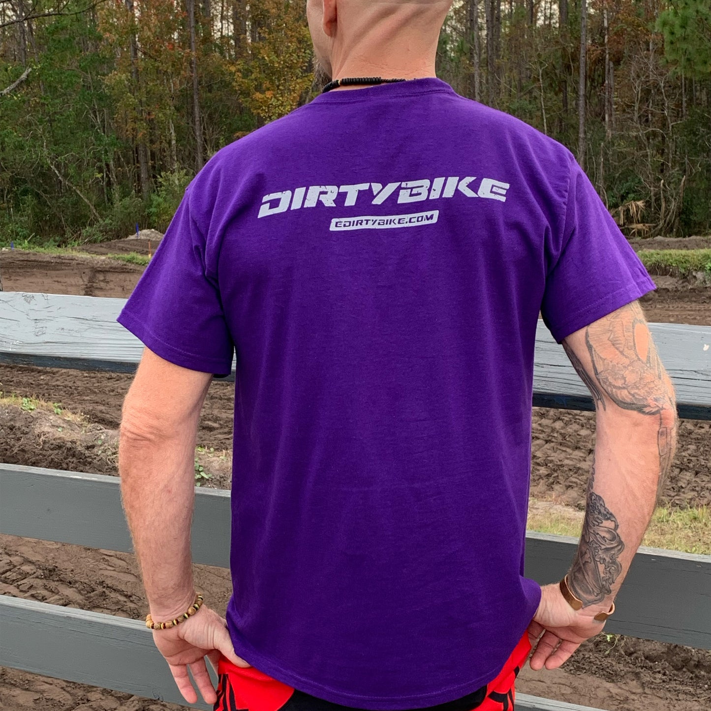 Back view of DirtyBike T-shirt in purple with stylish logo design.