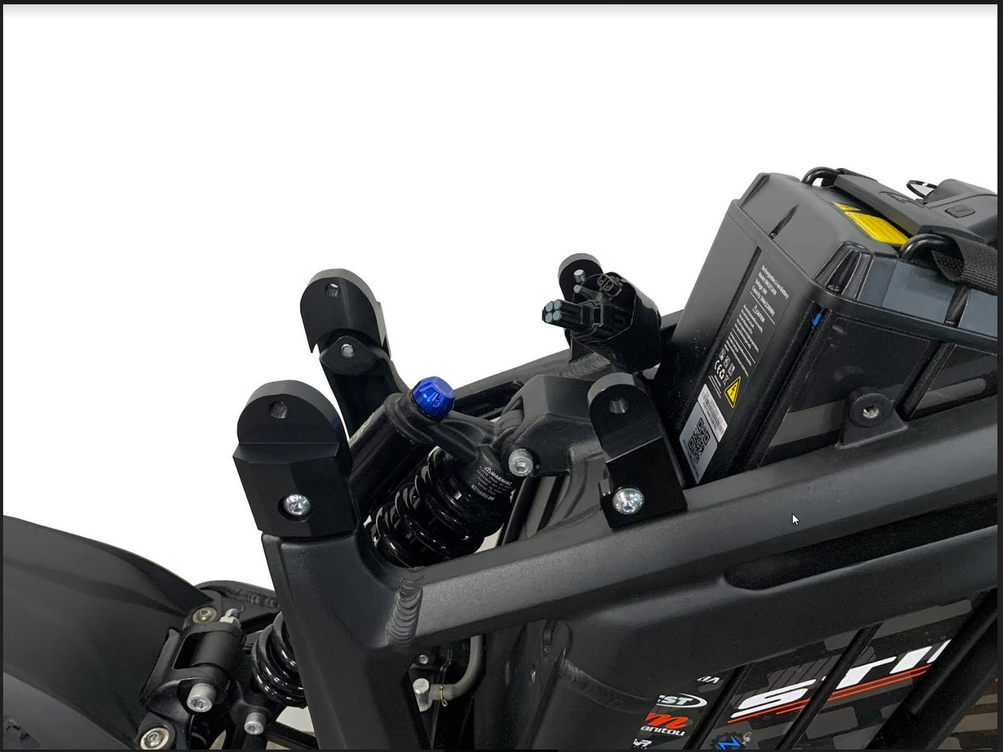 Talaria Sting seat riser securely installed on the bike frame.