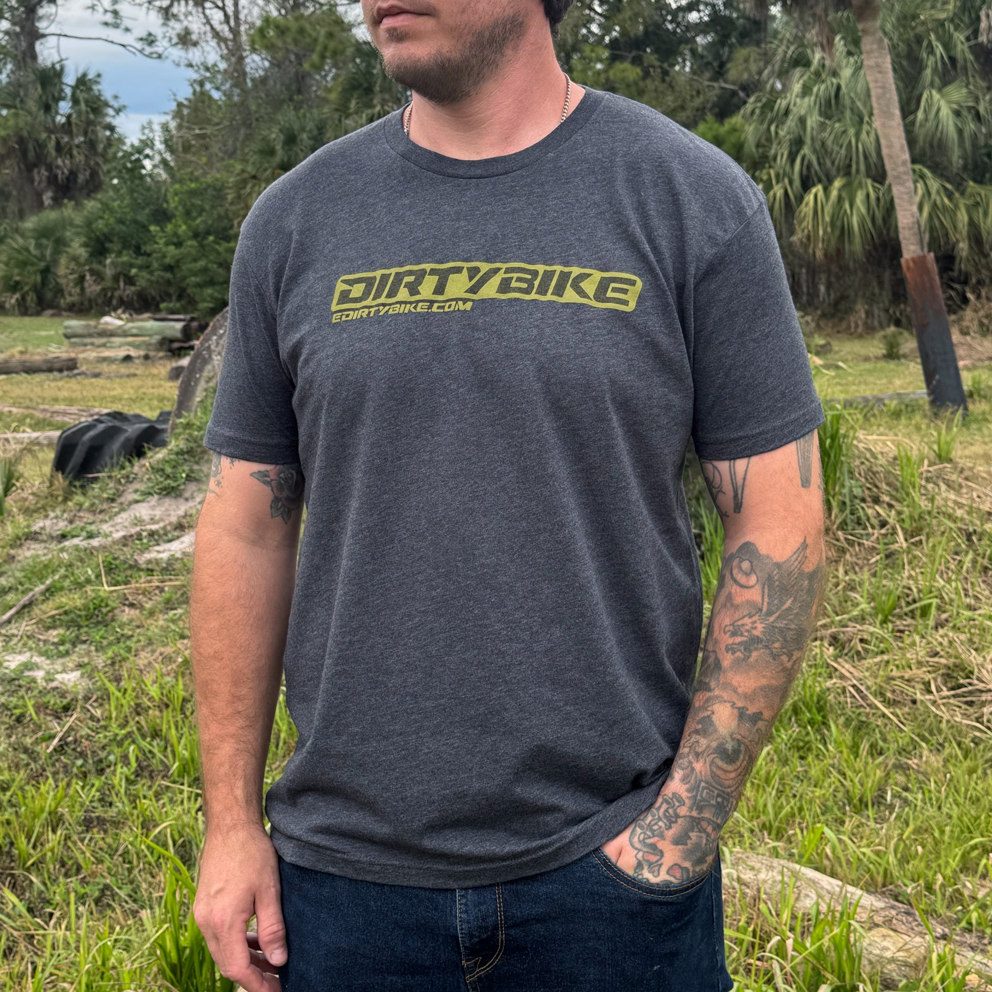 Man wearing a 'DIRTYBIKE' t-shirt outdoors in a natural setting