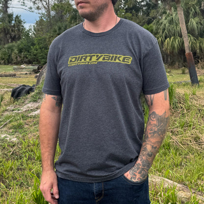 Man wearing a 'DIRTYBIKE' t-shirt outdoors in a natural setting