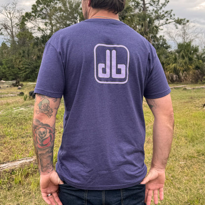 Person wearing a purple t-shirt with a db logo outdoors